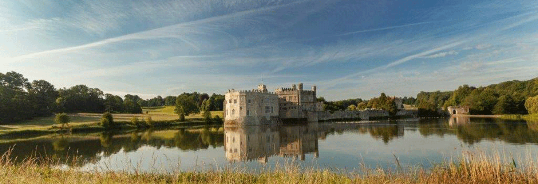 Leeds Castle across the Mote in the late summer with a reflection